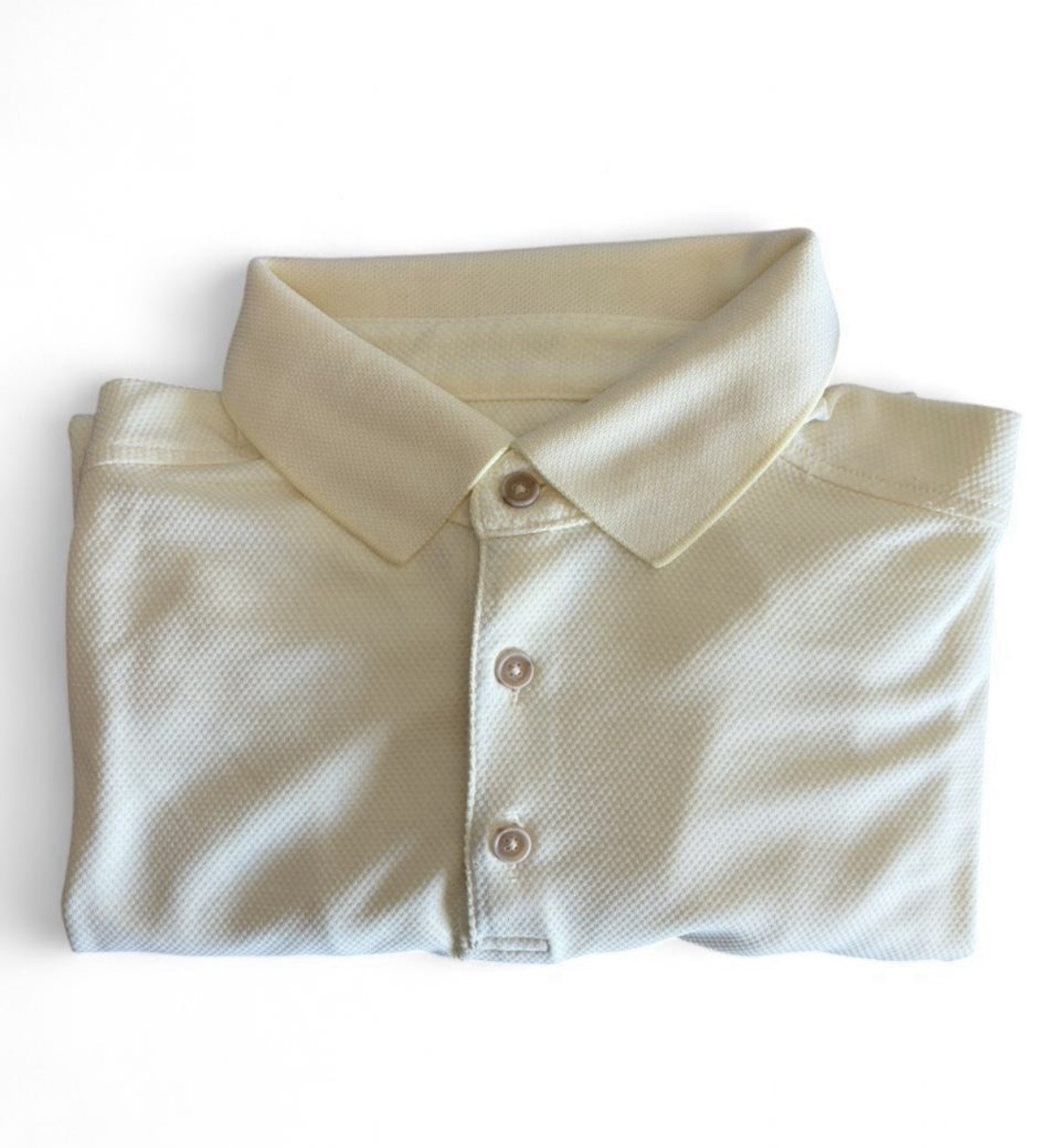 Tommy Bahama light buttery yellow polo shirt in Size L. Lightly textured fabric