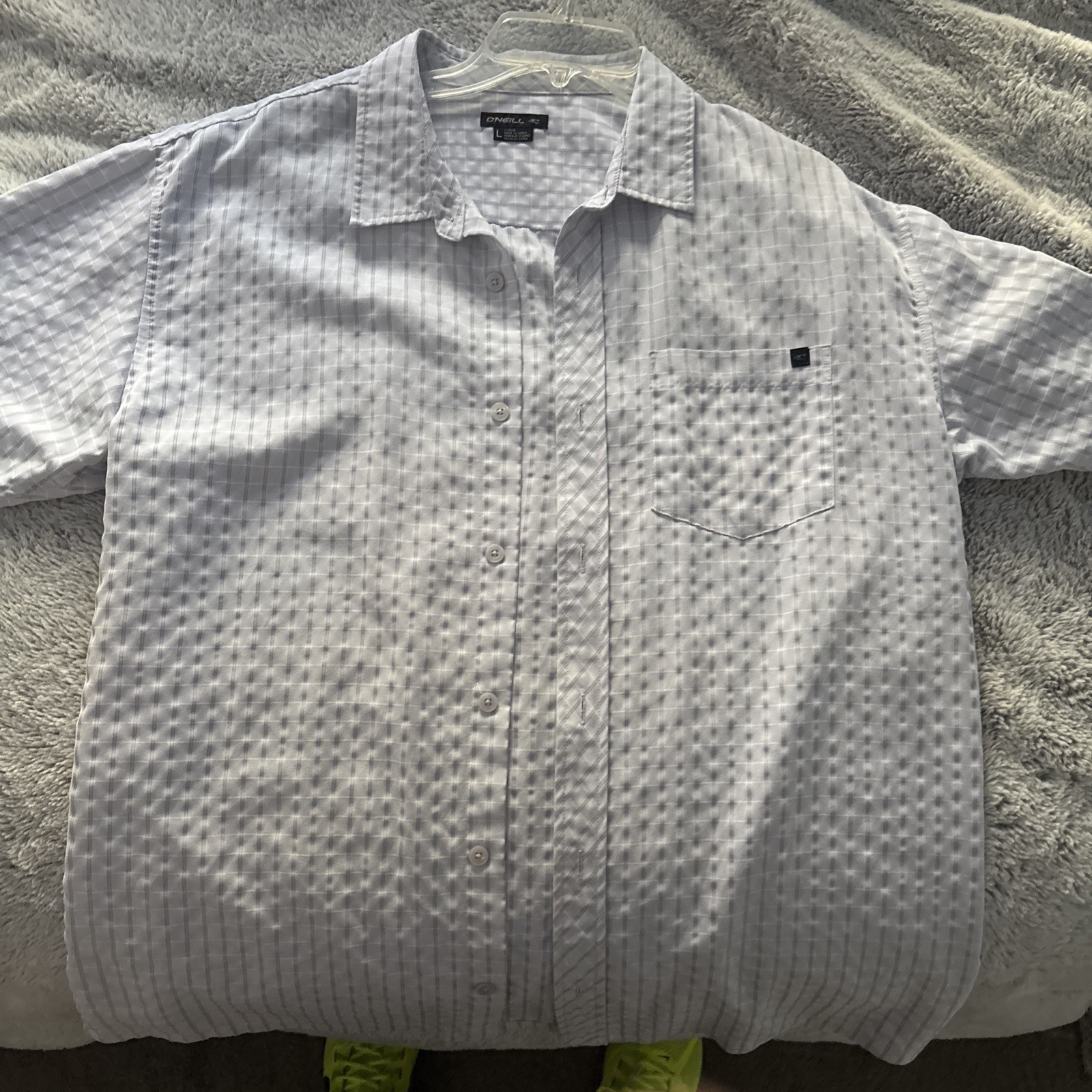 O’Neil shortsleeve button-up shirt featuring a textured light blue white fabric